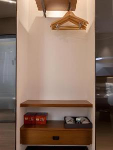 a room with a shelf with two boxes on it at Borrman Hotel Guilin Railway Station Two Rivers and Four Lakes in Guilin