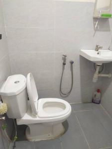 a bathroom with a toilet and a sink at Teratak Desa Cemerlang 2 in Kuala Kangsar