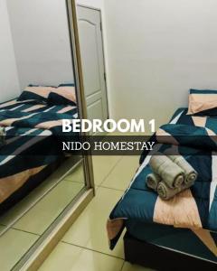 a bedroom with a mirror next to a bed at Home at Port Dickson in Port Dickson