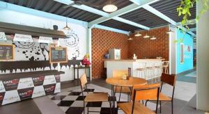 a fast food restaurant with a table and chairs at Umah Bali Suites in Denpasar