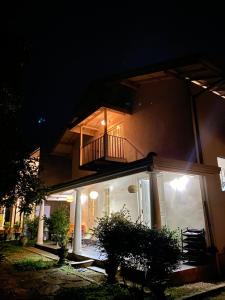 a house with a balcony on the side of it at night at Villa Peace & Plenty in Galle