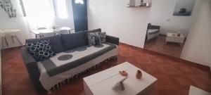 a living room with a couch and a table at Tarrafal snuggle in Tarrafal