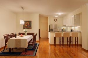 a dining room and kitchen with a table and chairs at Mayfair Hanoi in Hanoi