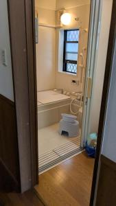 a bathroom with a shower and a toilet in it at いちごハウス in Zushi