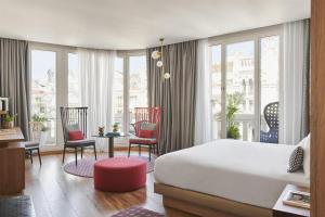 a bedroom with a bed and a table and chairs at Hyatt Centric Gran Via Madrid in Madrid +144 photos