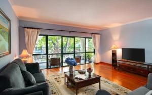 a living room with a couch and a tv at Mayfair Hanoi in Hanoi