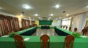 a large meeting room with a green table and chairs at Lucky Star Hotel in Phnom Penh +20 photos