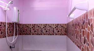 a bathroom with a shower with a sink and a toilet at Roong Arun Resort in Pumriang