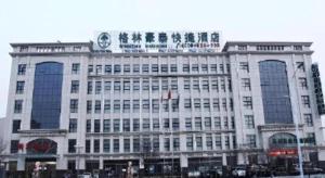 a large building with a sign on top of it at GreenTree Inn Hebei Zhangjiakou Xiahuayuan Xinchen Road Express Hotel in Dingfangshui