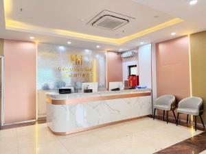 a hotel lobby with a counter with stools at Crowne Plaza Hotel in Bắc Ninh