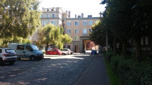 a street with cars parked on the side of the road at A3XD Apartament in Częstochowa