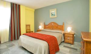 a bedroom with a bed with a red blanket at Ona Campanario in La Cala de Mijas