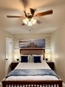 a bedroom with a bed with a ceiling fan at Casita-La Casa Contenta in El Paso