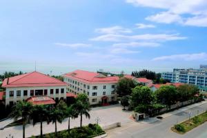 a group of buildings with red roofs on a street at Hotel Thanh loi in Mỹ Ðuc