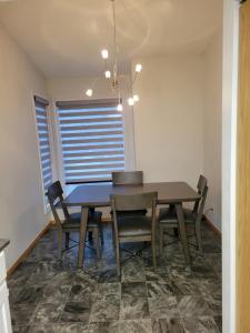 a dining room with a table and chairs at Singleton Room in a pet and smoke-free home in Winnipeg
