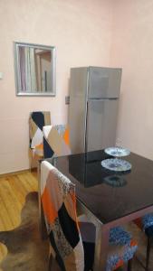 a dining room with a table and a refrigerator at апартамент Климент in Varna City