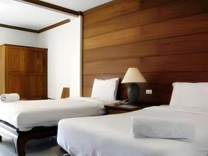 Postel nebo postele na pokoji v ubytování Fah Place Hotel
