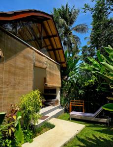 a building with a porch with a porch at Twiny's in Kuta Lombok