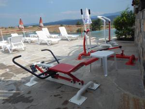 a group of exercise equipment on a patio with chairs at Yagnevo Complex in Yagnevo