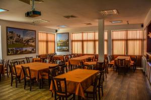 a dining room with tables and chairs and windows at Yagnevo Complex in Yagnevo