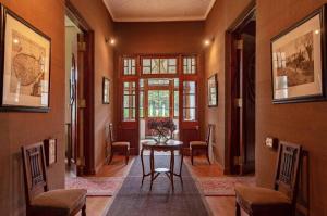 a hallway with a table and chairs in a house at Craigbank Nuwaraeliya in Nuwara Eliya