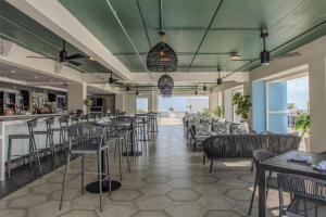 a bar with chairs and tables in a restaurant at Hyatt Place St Augustine Vilano Beach in Saint Augustine