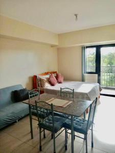 a living room with a table and a couch at Condo Unit near Ayala Serin Mall in Tagaytay
