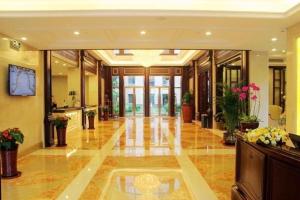 a large lobby with a lot of plants and flowers at Sky World Hotel Qingdao in Qingdao