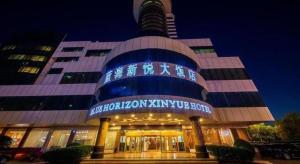 a building with a sign on the front of it at Dongying Blue Horizon Xinyue Hotel in Dongying