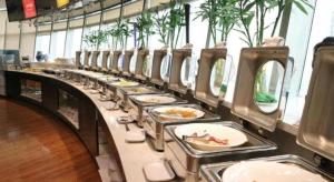 a buffet line of plates of food in a restaurant at Dongying Blue Horizon Xinyue Hotel in Dongying