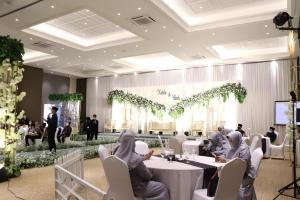 a group of people sitting at tables in a banquet hall at Fitra Hotel Majalengka in Majalengka