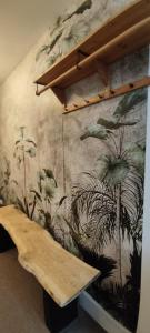 a mural on a wall with a wooden bench at Cheltenham town centre with parking space in Cheltenham