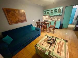 a living room with a blue couch and a table at La Casa De Don Rámon in Guadalajara