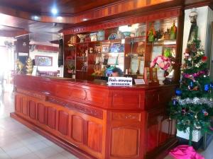 a bar with a christmas tree behind it at Sisavath Hotel in Ban Houadông
