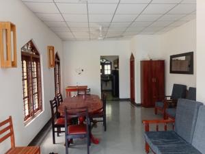 a dining room with a table and chairs at Villa Blancas in Matara