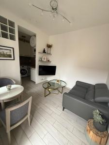 a living room with a couch and a table at Bright and comfortable appartment close to Tram T9 & Paris in Vitry-sur-Seine