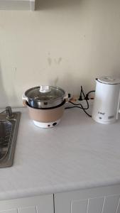 a pot sitting on a counter next to a toaster at Luxury 2BR Sea View by Superstay in Batam Center +10 photos