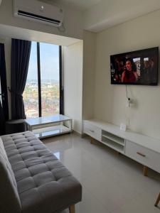 a living room with a tv on the wall at Luxury 2BR Sea View by Superstay in Batam Center