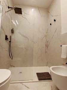 a bathroom with a shower and a toilet and a sink at Relais Santa Lucia sul Mare, Napoli in Naples +47 photos