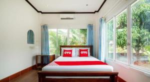 a bedroom with a bed and a large window at OYO 1036 Ban Bum Resort in Ban Pa Khan +63 photos