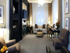 a living room with a couch and chairs and a table at Fifteen Beacon Hotel in Boston