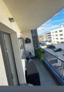 a balcony with a view of a parking lot at H pipera in Voluntari