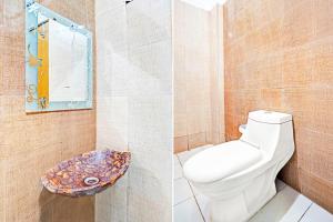 a bathroom with a toilet and a mirror at Collection O Prabhat Nagar Bareilly in Bareilly
