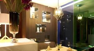 un restaurante con una mesa con un jarrón de flores. en Shenyang Holz Hotel, en Shenyang