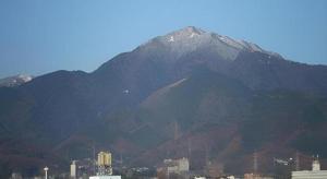 a mountain in the distance with a city and buildings at Isehara Green Palace Hotel in Isehara