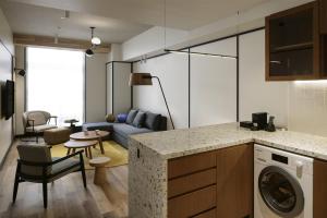 a kitchen and living room with a couch and a table at Caption By Hyatt Kabutocho Tokyo in Tokyo