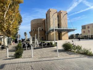 a building with tables and chairs in front of it at Sweet NiMa in Francavilla al Mare