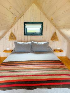 a bedroom with a large bed in a attic at Rio Arriba Ecoloft in El Culenar