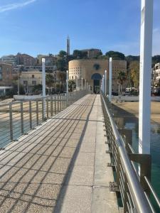 a bridge over a body of water with a building at Sweet NiMa in Francavilla al Mare +7 photos