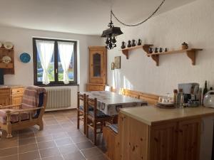 a kitchen with a table and chairs in a room at 031 Trilocale piano terra, Giustino in Giustino +11 photos